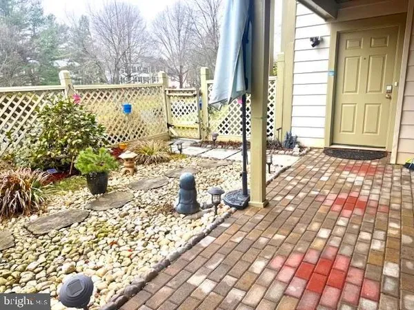 a street sign on a wall next to a road