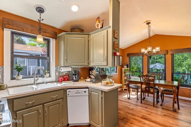 a kitchen with sink and view of living room
