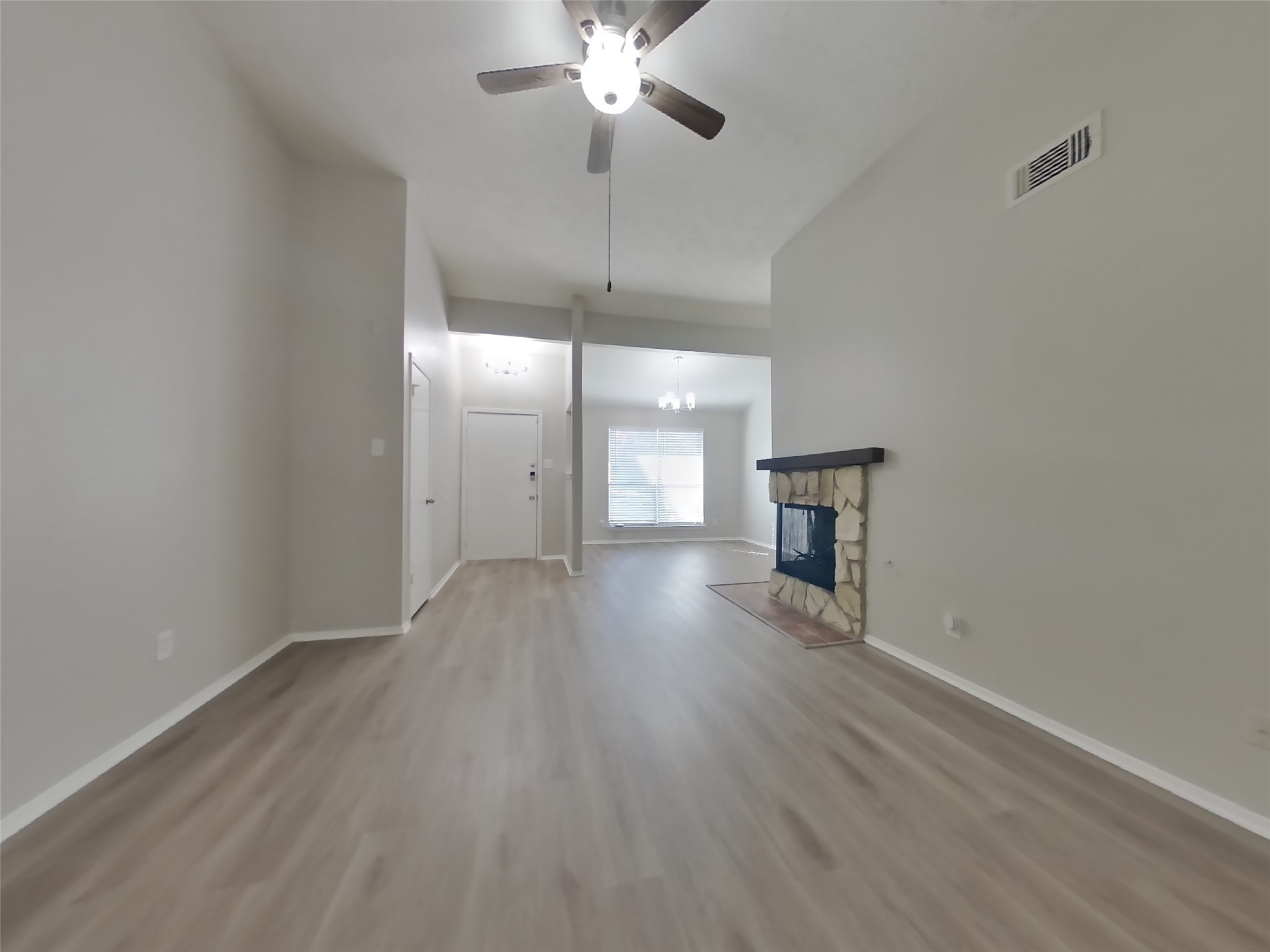 17226 Modbury Drive Spring, TX 77379 - Photo 2 of 20 a view of an empty room with wooden floor and a ceiling fan