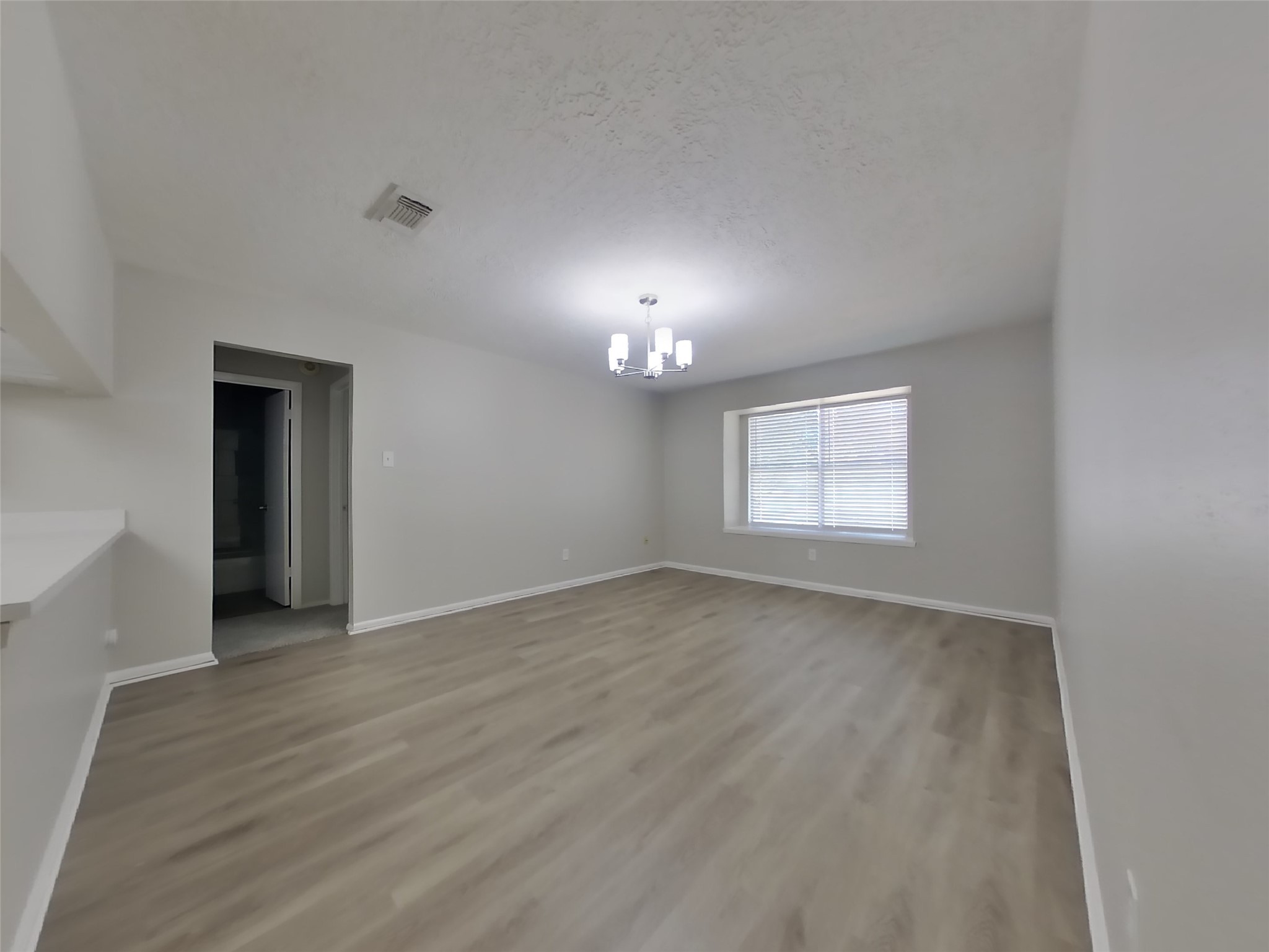 17226 Modbury Drive Spring, TX 77379 - Photo 4 of 20 a view of an empty room with a window and wooden floor