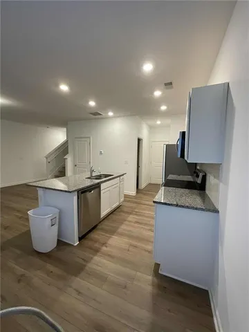 a large kitchen with a sink and a stove top oven
