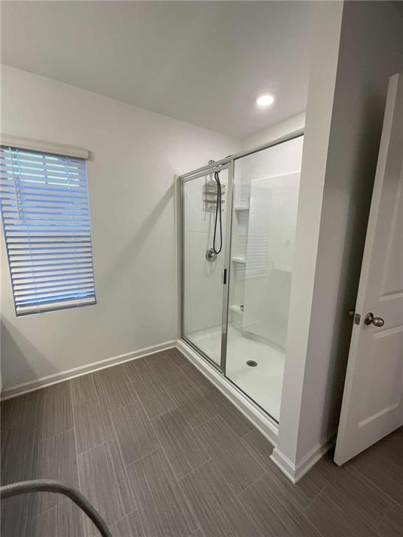 1410 Ben Park Way Grayson, GA 30017 - Photo 8 of 10 a view of an empty room with wooden floor and a window