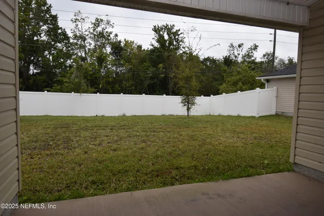 a view of a field with an ocean view