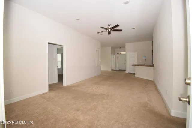 a view of a big room with closet and windows