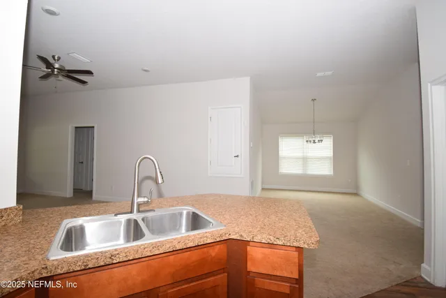 a kitchen with a sink cabinets and window
