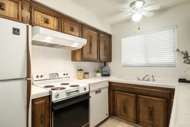 a kitchen that has a sink and a stove