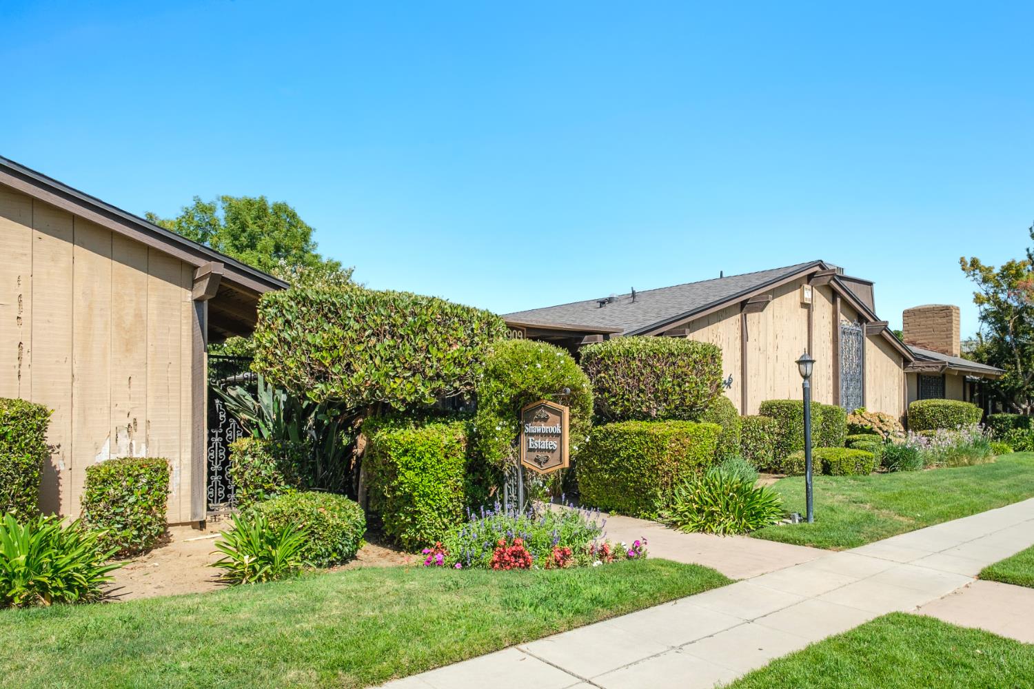 4849 North 7th Street, Unit F Fresno, CA 93726 - Photo 13 of 23 a front view of a house with garden
