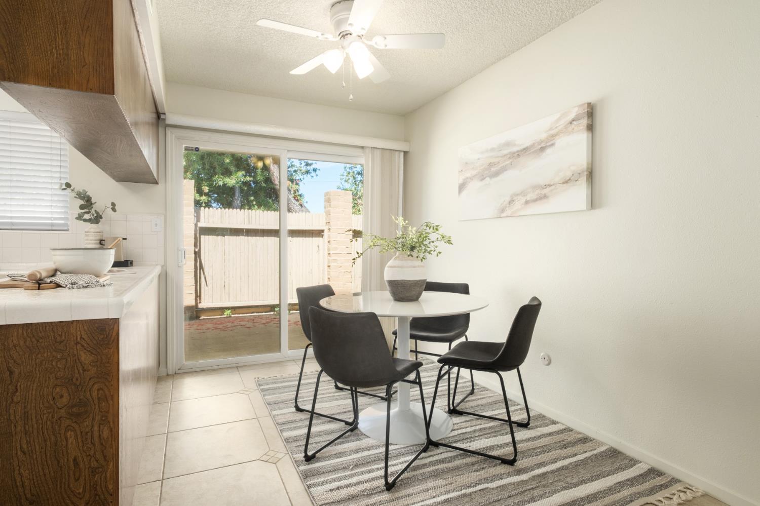 4849 North 7th Street, Unit F Fresno, CA 93726 - Photo 15 of 23 a dining room with furniture a chandelier and wooden floor