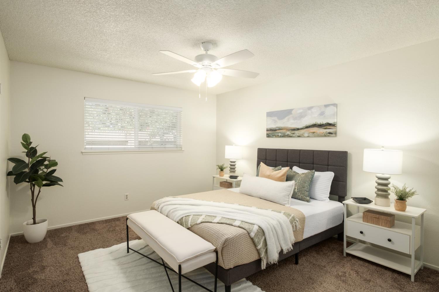 4849 North 7th Street, Unit F Fresno, CA 93726 - Photo 19 of 23 a bedroom with a bed and a chandelier
