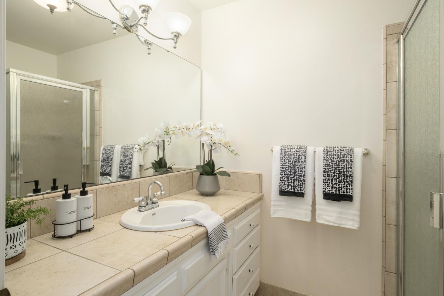 4849 North 7th Street, Unit F Fresno, CA 93726 - Photo 20 of 23 a bathroom with double vanity sinks and a mirror