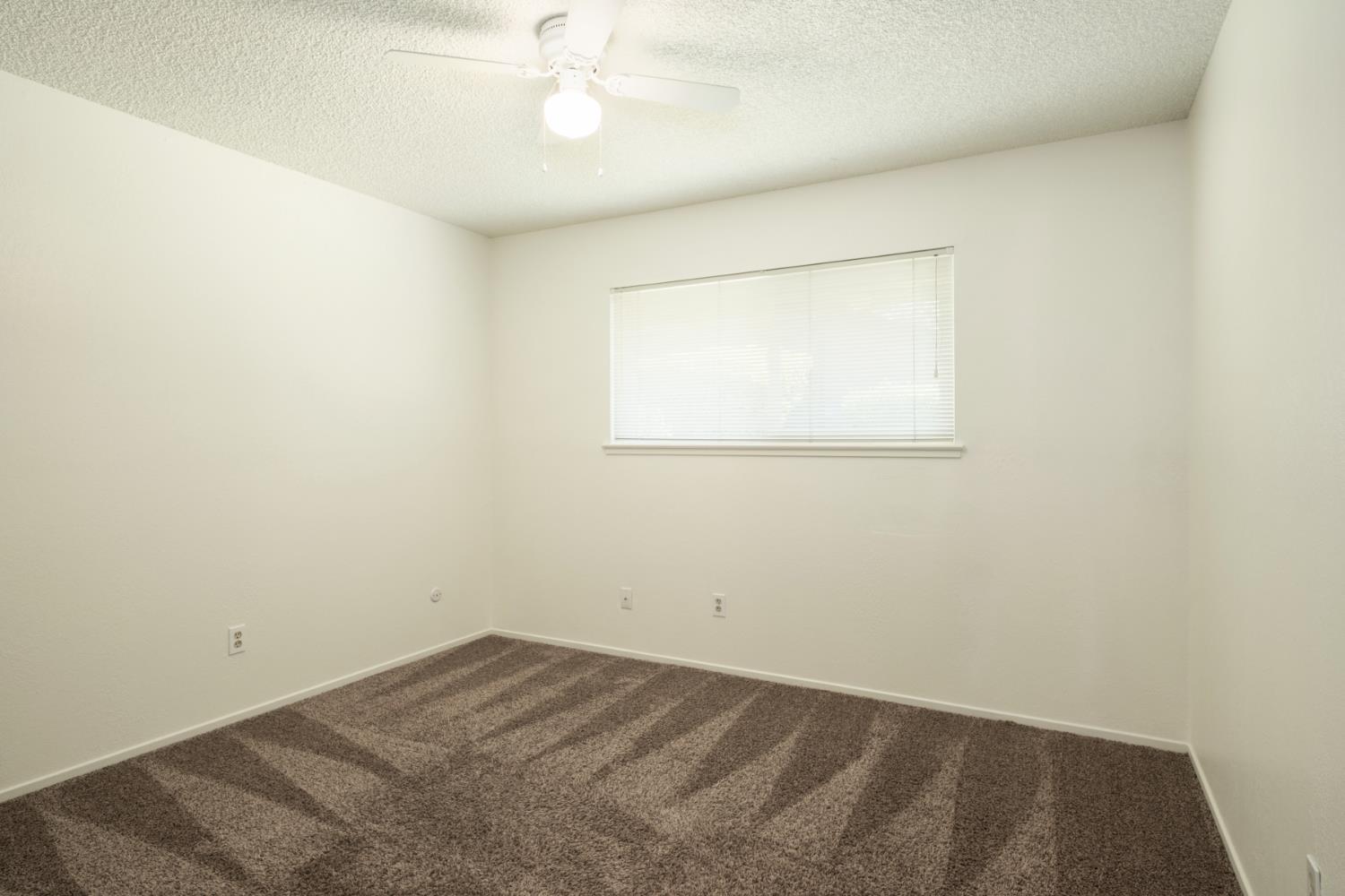 4849 North 7th Street, Unit F Fresno, CA 93726 - Photo 21 of 23 an empty room with a window