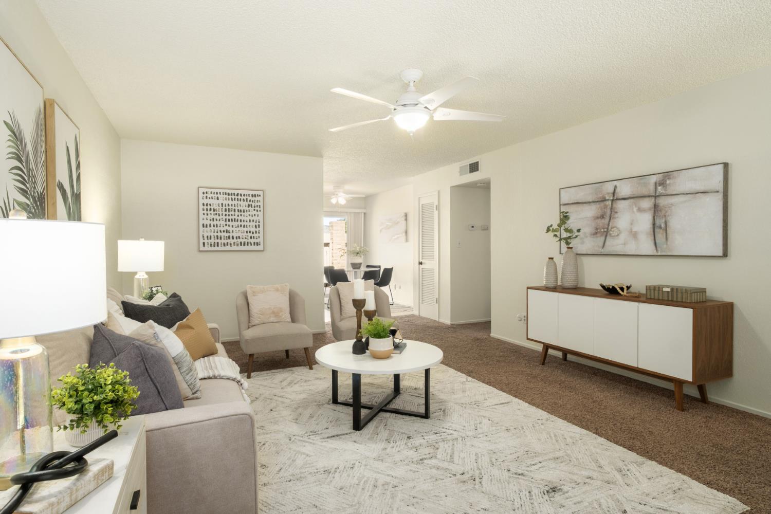 4849 North 7th Street, Unit F Fresno, CA 93726 - Photo 6 of 23 a living room with furniture and a chandelier