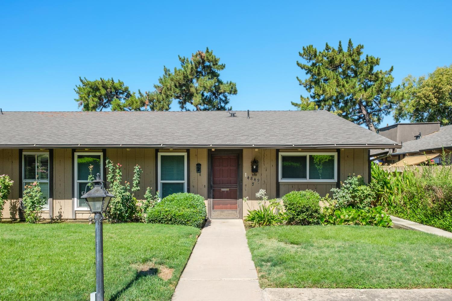 4849 North 7th Street, Unit F Fresno, CA 93726 - Photo 7 of 23 a front view of a house with a garden