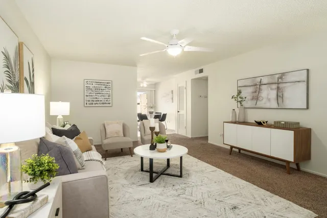 a living room with furniture and a chandelier
