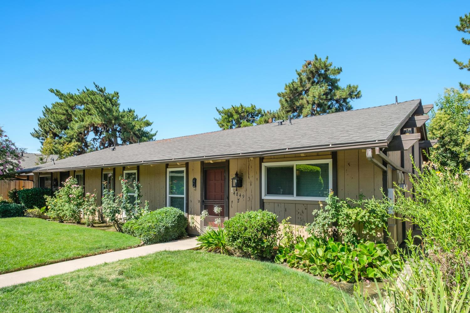 4849 North 7th Street, Unit F Fresno, CA 93726 - Photo 8 of 23 a front view of a house with a yard