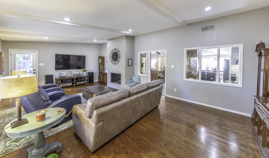 3620 93rd Street Lubbock, TX 79423 - Photo 6 of 33 a living room with furniture and a flat screen tv