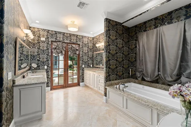 a bedroom with a bed and a lamp on dresser