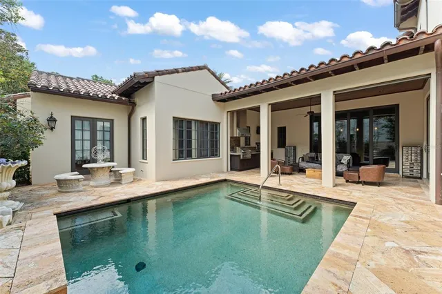 a view of a patio with table and chairs with wooden floor and plants