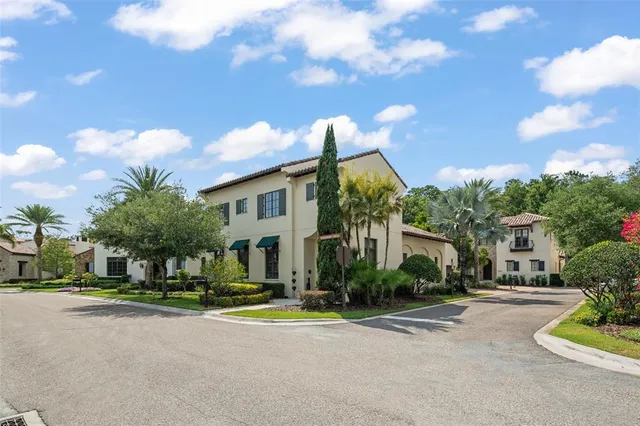a view of a white house with a yard and plants