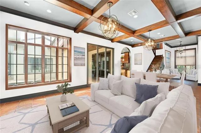a living room with furniture and floor to ceiling windows