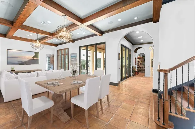 a dining room with furniture a rug and a chandelier