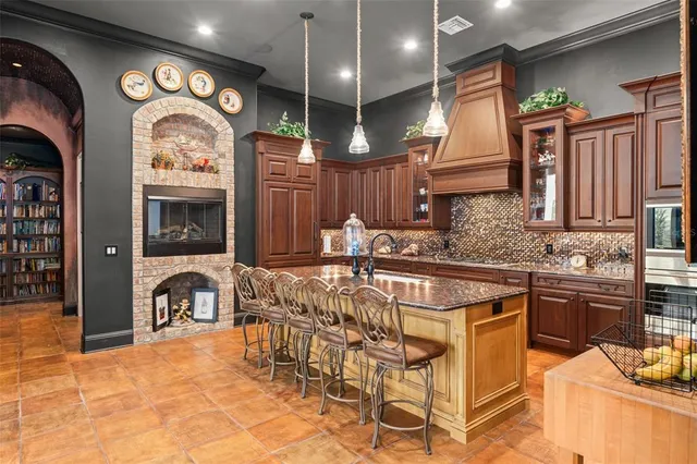 a kitchen with stainless steel appliances granite countertop a sink and a refrigerator