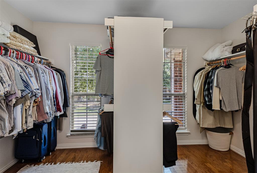9301 Nottingham Court Rowlett, TX 75088 - Photo 15 of 39 Walk-in closet featuring wood-finish flooring, multiple hanging rods, and two windows with blinds