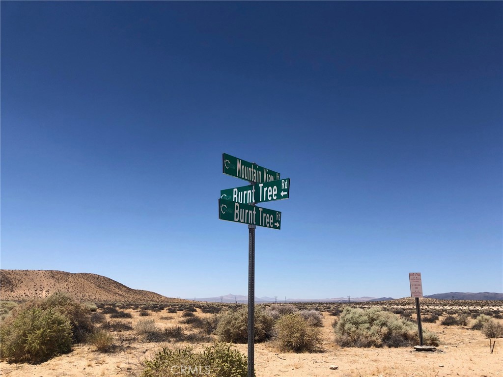 0 American Way Hinkley, CA 92347 - Photo 8 of 16 a street sign on a pole with a mountain in the background