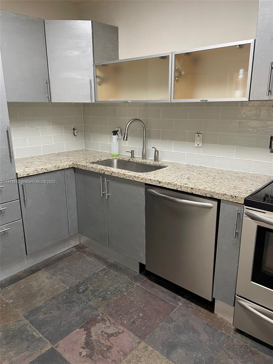 Normandy Beach Surfside, FL 33154 - Photo 13 of 32 a kitchen with sink and cabinets