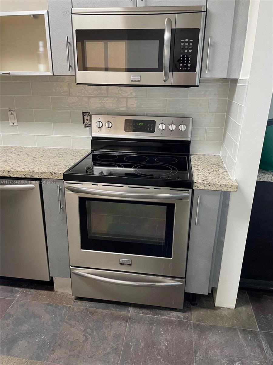 Normandy Beach Surfside, FL 33154 - Photo 14 of 32 a stove top oven sitting inside of a kitchen
