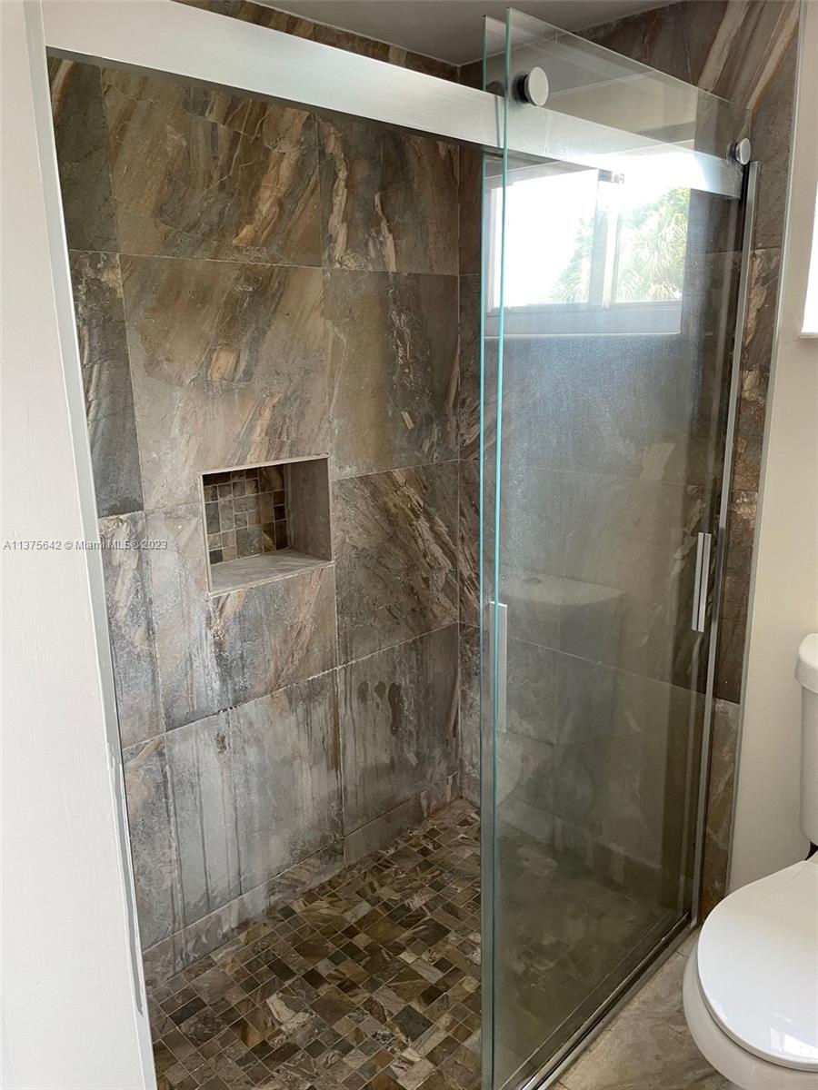 Normandy Beach Surfside, FL 33154 - Photo 30 of 32 a bathroom with a shower and toilet