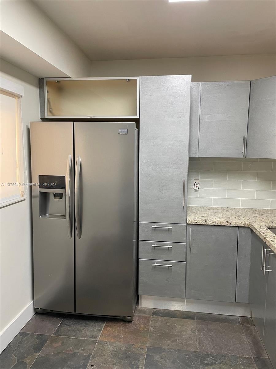 Normandy Beach Surfside, FL 33154 - Photo 10 of 32 a view of a refrigerator in kitchen and cabinets