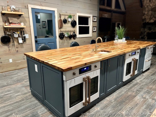 4119 Minnie Hall Road Autryville, NC 28318 - Photo 5 of 16 a kitchen with stainless steel appliances granite countertop wooden cabinets and wooden floor