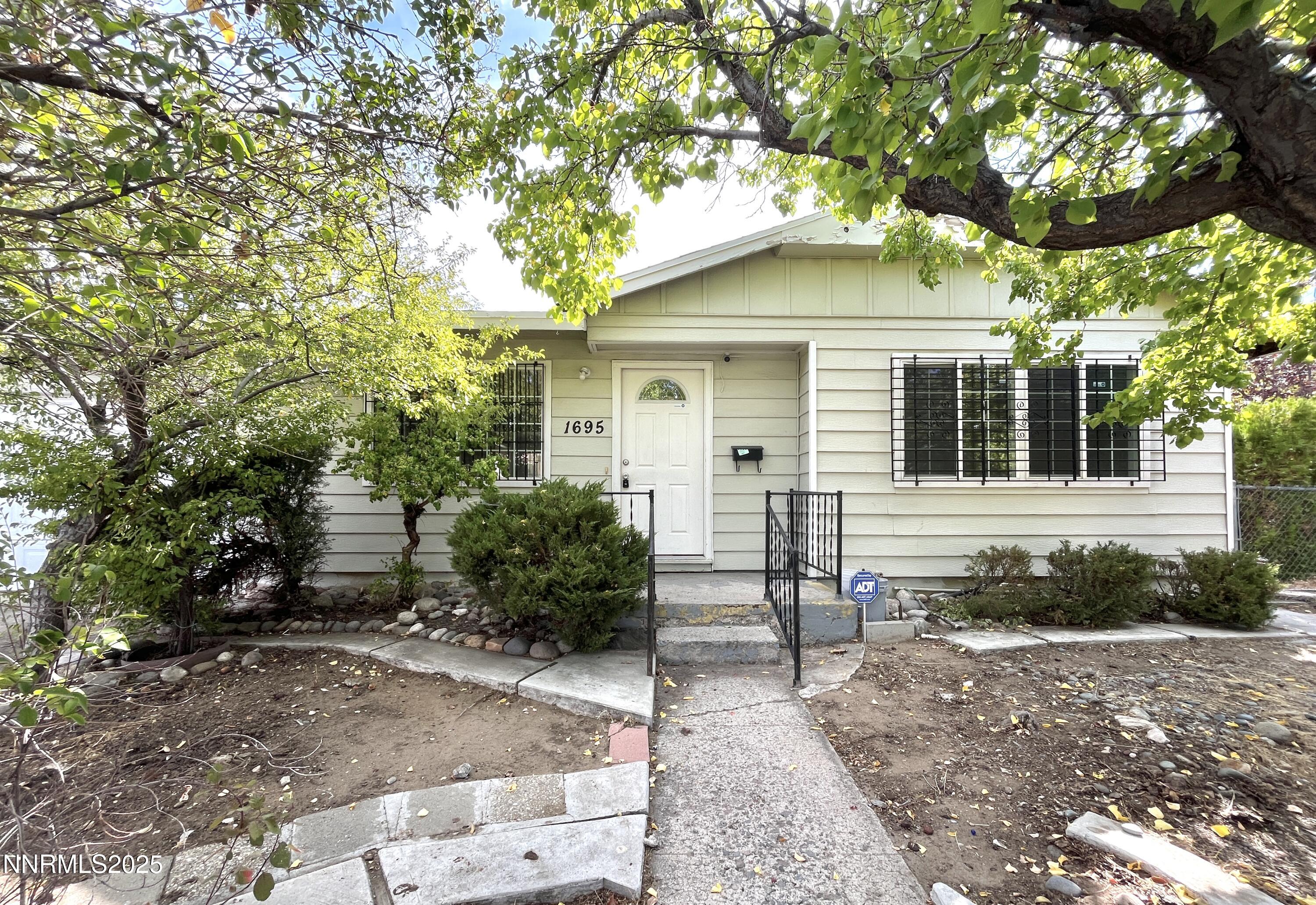 1695 Trabert Way Sparks, NV 89431 - Photo 1 of 17 a front view of a house with garden