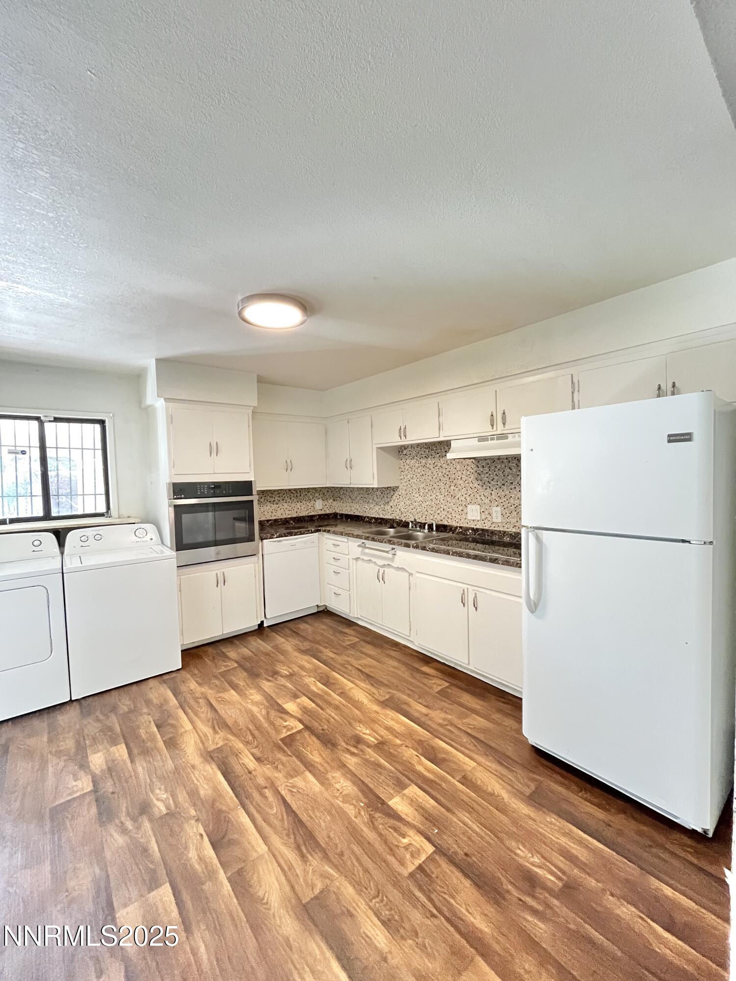 1695 Trabert Way Sparks, NV 89431 - Photo 2 of 17 a kitchen with white cabinets and white appliances