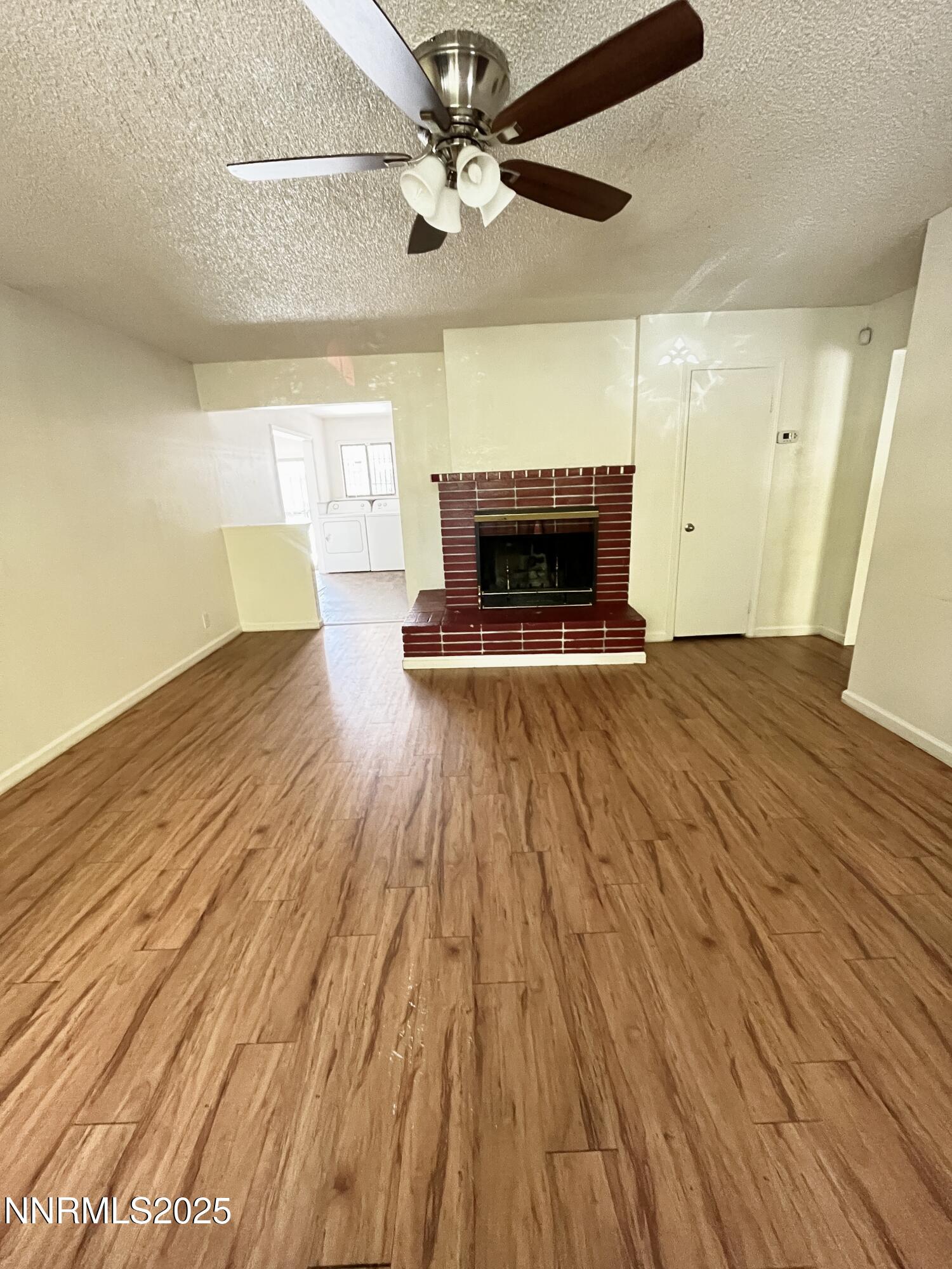 1695 Trabert Way Sparks, NV 89431 - Photo 6 of 17 a view of empty room with wooden floor and fireplace
