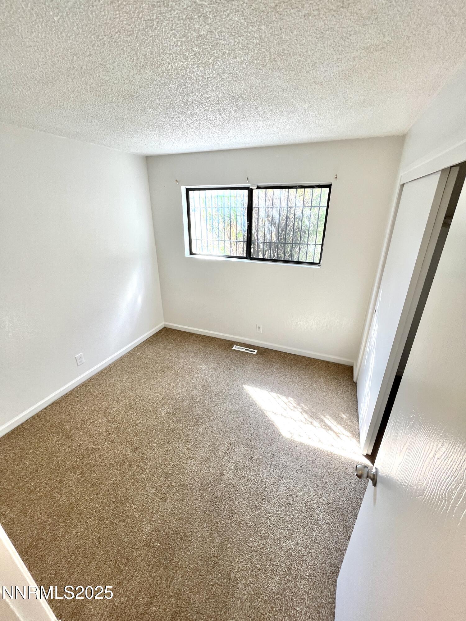 1695 Trabert Way Sparks, NV 89431 - Photo 10 of 17 an empty room with wooden floor and windows