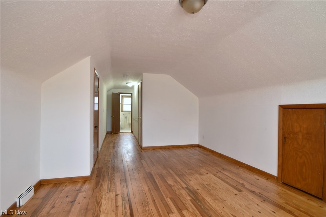 3681 Brinkmore Road Cleveland Heights, OH 44121 - Photo 20 of 27 Bedroom with lofted ceiling, light wood-type flooring, and a textured ceiling