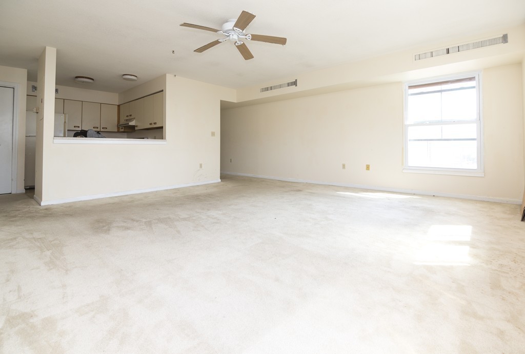 50 South Common Street, Unit 403 Lynn, MA 01902 - Photo 5 of 16 a view of a kitchen with a dishwasher and a white cabinets