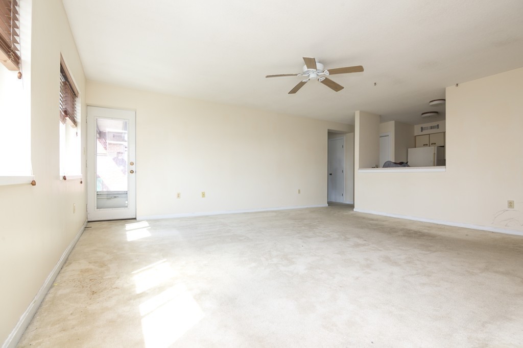 50 South Common Street, Unit 403 Lynn, MA 01902 - Photo 6 of 16 a view of a livingroom with a ceiling fan and window