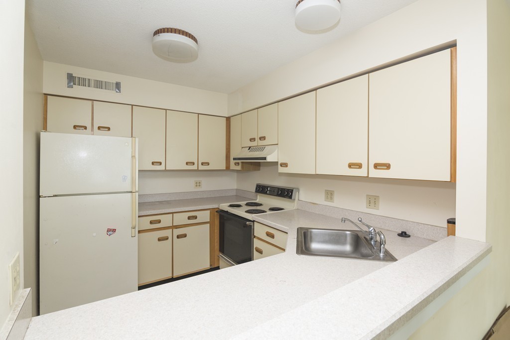 50 South Common Street, Unit 403 Lynn, MA 01902 - Photo 8 of 16 a kitchen with a sink a stove and refrigerator