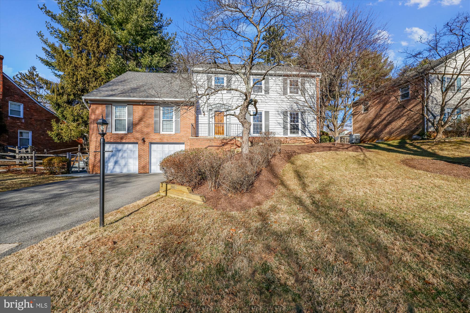 a view of a house with a yard covered in snow