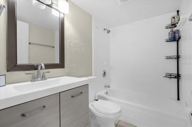 a bathroom with a sink a toilet and mirror