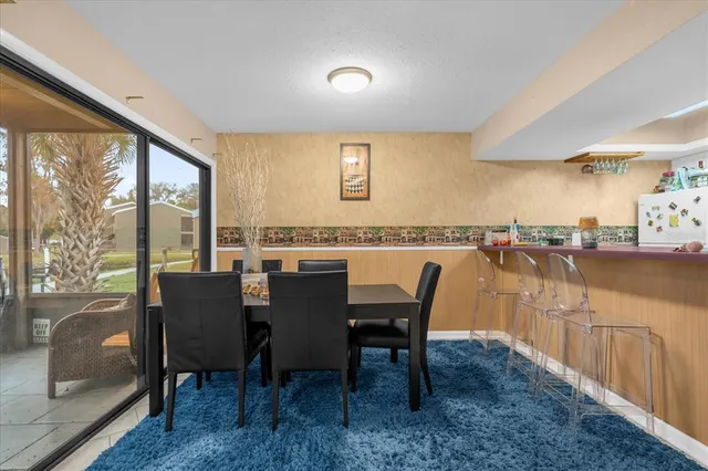 a view of a dining room with furniture and a window