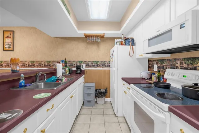 a kitchen with a sink a counter top space and appliances