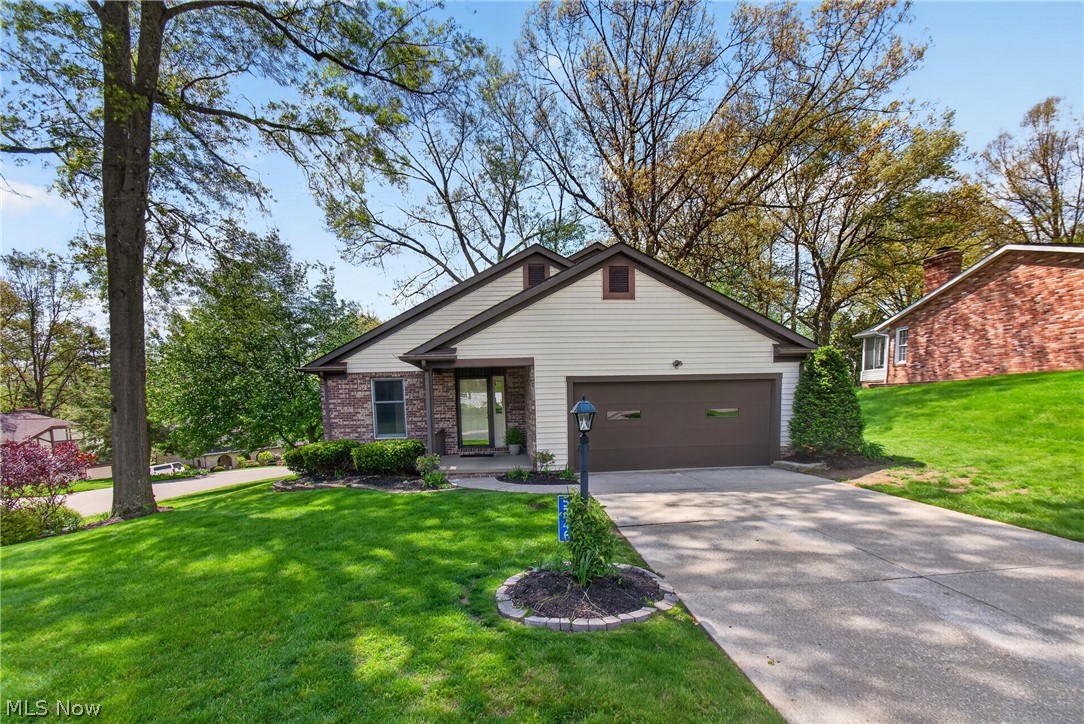 5346 Burlawn Street Northwest Canton, OH 44708 - Photo 1 of 40 Contemporary residence with a brick and siding facade, featuring an integrated two-car garage