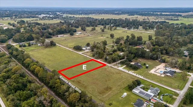 an aerial view of residential houses with outdoor space and river