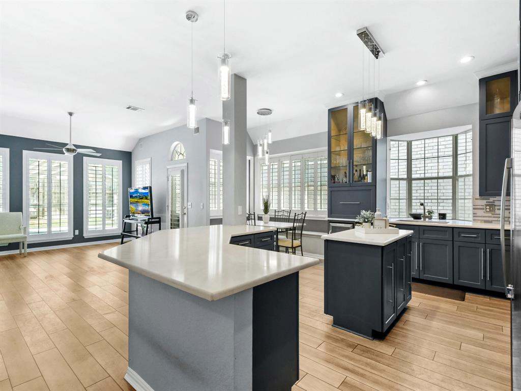 4025 Azure Lane Addison, TX 75001 - Photo 12 of 40 a large kitchen with kitchen island a sink stainless steel appliances and cabinets