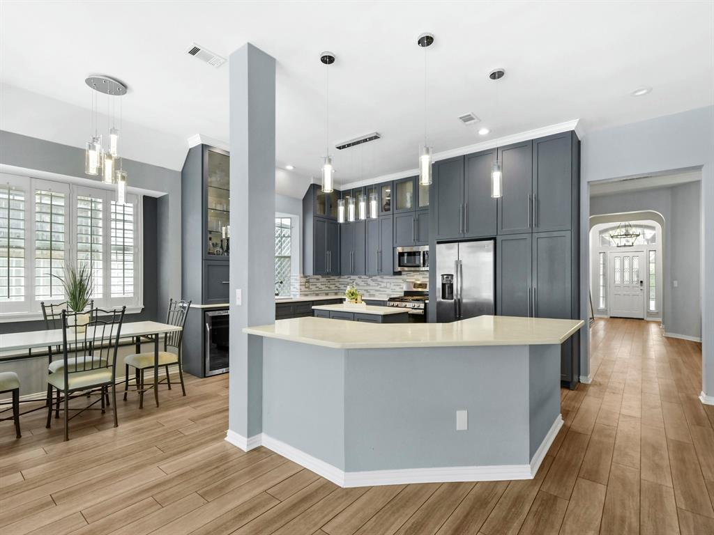 4025 Azure Lane Addison, TX 75001 - Photo 13 of 40 a view of kitchen with stainless steel appliances granite countertop wooden floors and a view of living room