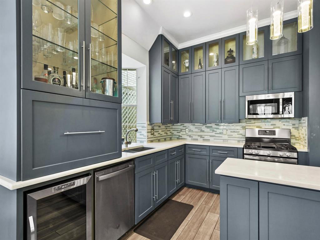4025 Azure Lane Addison, TX 75001 - Photo 14 of 40 a kitchen with stainless steel appliances a sink stove and cabinets